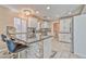A modern kitchen with granite countertops, stainless steel appliances, and convenient bar seating at 7581 Slipstream St, Las Vegas, NV 89139