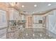 A well-lit kitchen featuring granite countertops, stainless steel appliances, and white cabinetry at 7581 Slipstream St, Las Vegas, NV 89139