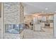 A spacious, open-concept living area with a stone fireplace, adjacent dining space, and a modern kitchen at 7581 Slipstream St, Las Vegas, NV 89139