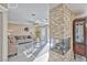 Bright living room with stone fireplace and neutral decor leading to outdoor patio at 7581 Slipstream St, Las Vegas, NV 89139