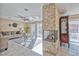 Bright living room with stone fireplace and neutral decor leading to outdoor patio at 7581 Slipstream St, Las Vegas, NV 89139