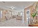 Inviting living room features tile floors, neutral tones, and a seamless flow to the dining area at 7581 Slipstream St, Las Vegas, NV 89139