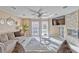 Spacious living room with fireplace, ceiling fan, and view of outdoor pool area at 7581 Slipstream St, Las Vegas, NV 89139