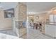 Living and dining area with stone fireplace, view of the kitchen, and sleek tile flooring at 7581 Slipstream St, Las Vegas, NV 89139