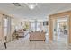 Bright living room features neutral tones, tile floors, fireplace, and sliding door access to an outdoor patio at 7581 Slipstream St, Las Vegas, NV 89139