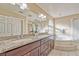Elegant main bathroom with a granite countertop, dual sinks, and a separate shower and tub at 7581 Slipstream St, Las Vegas, NV 89139