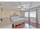 Serene main bedroom with hardwood floors, ceiling fan, and a well-lit ambiance at 7581 Slipstream St, Las Vegas, NV 89139