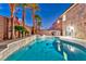 Backyard featuring a stunning pool, spa, tropical landscaping, and privacy walls at 7581 Slipstream St, Las Vegas, NV 89139