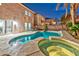 Backyard featuring a stunning pool and a relaxing hot tub at 7581 Slipstream St, Las Vegas, NV 89139