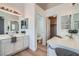 Bright bathroom features dual sinks, white cabinetry, and a separate toilet room at 800 Fetter Ct, Henderson, NV 89052