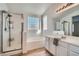 Bathroom with shower, soaking tub, and dual sinks with modern vanity and decor at 800 Fetter Ct, Henderson, NV 89052