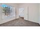 Bright bedroom with neutral carpet, large windows, and view to the hallway at 800 Fetter Ct, Henderson, NV 89052