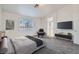 A carpeted bedroom features TV, view of bathroom, and plenty of natural light at 800 Fetter Ct, Henderson, NV 89052