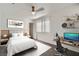 Staged bedroom with bed, desk, ceiling fan and lots of light at 800 Fetter Ct, Henderson, NV 89052