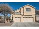 Two-story home with a well-maintained front yard, mature tree, and a two car garage at 800 Fetter Ct, Henderson, NV 89052