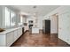 Contemporary kitchen with white cabinets, stainless appliances, quartz counters, and hardwood floors at 800 Fetter Ct, Henderson, NV 89052