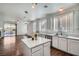 Modern kitchen with white cabinets, stainless steel appliances, and a view to a living area at 800 Fetter Ct, Henderson, NV 89052