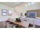 Open-concept living room and dining area with stylish furniture and a tall, vaulted ceiling at 800 Fetter Ct, Henderson, NV 89052