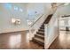 Sunlit living room with hardwood floors, staircase, and large windows overlooking the yard at 800 Fetter Ct, Henderson, NV 89052