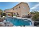 Private pool with rock accents, complemented by lush landscaping and a view of the home's exterior at 800 Fetter Ct, Henderson, NV 89052