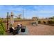 Charming backyard features a patio, seating area with an umbrella, and playhouse for . Ready for outdoor enjoyment at 8432 Alder Rain St, Las Vegas, NV 89113