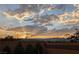 Scenic backyard sunset view featuring majestic mountains, lush greenery, and vibrant skyline at 8432 Alder Rain St, Las Vegas, NV 89113