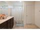 Clean bathroom with a shower and a vanity with decorative floral accents, perfect for relaxation at 8432 Alder Rain St, Las Vegas, NV 89113