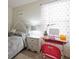 Well-lit bedroom featuring a desk, a nightstand, and soft, patterned curtains at 8432 Alder Rain St, Las Vegas, NV 89113