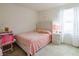 Bright bedroom with a polka dot comforter, a desk and a window at 8432 Alder Rain St, Las Vegas, NV 89113