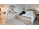 Charming bedroom features a light-colored wood bedroom set and accent chair at 8432 Alder Rain St, Las Vegas, NV 89113