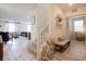 Inviting foyer with light wood-look floors and staircase, complemented by a stylish bench and decor at 8432 Alder Rain St, Las Vegas, NV 89113