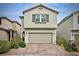Charming two-story home features a neutral-colored exterior, a two-car garage and low-maintenance landscaping at 8432 Alder Rain St, Las Vegas, NV 89113