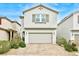 Charming two-story home features a neutral-colored exterior, a two-car garage and low-maintenance landscaping at 8432 Alder Rain St, Las Vegas, NV 89113