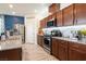 The modern kitchen features granite countertops, stainless steel appliances, wood cabinets and stylish backsplash at 8432 Alder Rain St, Las Vegas, NV 89113