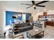 Bright, open living space featuring modern furnishings, a ceiling fan, dining area, and stylish kitchen with island at 8432 Alder Rain St, Las Vegas, NV 89113