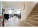Inviting living room with neutral tones, stairs to the upper level, and open floor plan at 8432 Alder Rain St, Las Vegas, NV 89113
