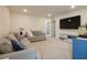 Cozy living room with plush seating, a large TV, and a calming neutral color palette at 8432 Alder Rain St, Las Vegas, NV 89113