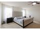 Serene main bedroom featuring a tufted headboard, neutral bedding, and bright natural light at 8432 Alder Rain St, Las Vegas, NV 89113