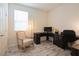 Bright office space with modern desk, chair, and decorative armchair near a window at 8432 Alder Rain St, Las Vegas, NV 89113