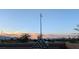 Sunset view showcasing the neighborhood behind the home, including desert landscaping and mountain views at 8432 Alder Rain St, Las Vegas, NV 89113