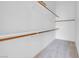 Organized closet featuring wooden bars and white shelving at 8805 Jeffreys St # 2082, Las Vegas, NV 89123