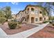 A charming condo building showcasing two stories with a walkway and manicured landscaping at 8805 Jeffreys St # 2082, Las Vegas, NV 89123