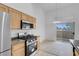 Bright kitchen features stainless steel appliances, gas range, and sliding door to patio at 8805 Jeffreys St # 2082, Las Vegas, NV 89123