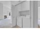Convenient laundry room with a washer and dryer and shelving at 8805 Jeffreys St # 2082, Las Vegas, NV 89123