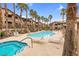 Community pool featuring lounge chairs and palm trees at 8805 Jeffreys St # 2082, Las Vegas, NV 89123