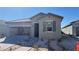Charming single-story home with neutral stucco, paver driveway, and partially open garage at 9067 Mapledale Ranch Ct, Las Vegas, NV 89139