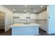 A modern kitchen with white cabinetry, a large island, and ample countertop space at 9067 Mapledale Ranch Ct, Las Vegas, NV 89139