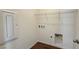 Functional laundry room with overhead shelving, utility connections, and convenient access for household tasks at 9067 Mapledale Ranch Ct, Las Vegas, NV 89139