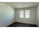 The expansive living room features two windows and a sliding glass door for lots of light at 9067 Mapledale Ranch Ct, Las Vegas, NV 89139