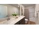 Bathroom features a double sink vanity, framed mirror, shower with curtain, and ample lighting for a refreshing experience at 9190 Oakdale Ranch Ct, Las Vegas, NV 89139